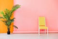 Interior of a pink room with colored chairs, armchairs