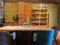 Interior of a room or a restaurant with wooden table and chairs for dining. Wine rack on the back. Royalty Free Stock Photo