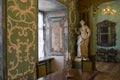 Interior of the room with table, chairs, statue in the ancient old castle