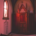 Interior of Saint John the Evangelist catholic church with confessor hearing room in Indianapolis