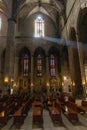 Interior of Santa Maria del Mar in Barcelona, Spain with a beam of light through the window