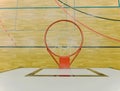 Interior of school gym with basketball board and basket. Safety nets over windows.