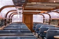 Interior seating inside a glass roofed sightseeing canal cruise trip boat for tourists Royalty Free Stock Photo
