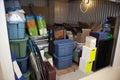 A storage unit full of boxes and plastic tubs Royalty Free Stock Photo