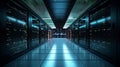 Interior of a server room, where server towers are visible on the left and right sides and a corridor runs through the center. Royalty Free Stock Photo