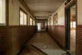 Interior shot of an empty hall of an abandoned school with broken doors Royalty Free Stock Photo