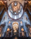 an interior of the Karlskirche cathedral with a vaulted dome is very ornate