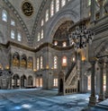 Interior shot of Nuruosmaniye Mosque with minbar platform, huge arches & colored stained glass windows, Istanbul, Turkey Royalty Free Stock Photo