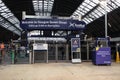 Interior shot of Queen Street Glasgow Railway Station during renovations. Shows ticket barriers, signage and information kiosk