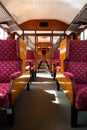 Interior shot of vintage railway carriage showing seating, ilse wooden trimmings and lugage rack