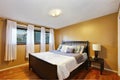 Interior of small bedroom with hardwood floor