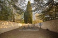 Interior of a small cemetery surrounded by majestic trees Royalty Free Stock Photo