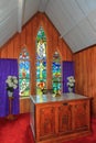 Interior of a small church, with altar and stained glass windows Royalty Free Stock Photo