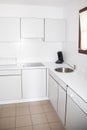 Small white kitchen clean and bright Royalty Free Stock Photo