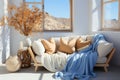 Interior with sofa with light blue and beige blankets and pillows, vases by the window. Copy space Royalty Free Stock Photo