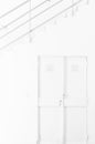 Interior space completely white: wall, door and staircase with handrail Royalty Free Stock Photo