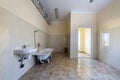 Interior of spacious light hospital or kindergarten bathroom with white bathtub, sink, air ventilation duct and tiled floor and Royalty Free Stock Photo