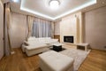 Interior of a specious living room with fireplace and luxury ceiling lights