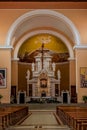 Interior of St. Stephen`s Catholic Church in Shkoder, vertical. Temple hall with wooden benches Royalty Free Stock Photo