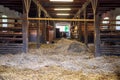 Interior of stable in horse breeding in Florianka, Zwierzyniec, Roztocze, Poland. Clean hay lying down on the floor. Drinker and Royalty Free Stock Photo