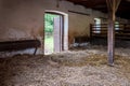 Interior of stable in horse breeding in Florianka, Zwierzyniec, Roztocze, Poland. Clean hay lying down on the floor. Drinker and Royalty Free Stock Photo