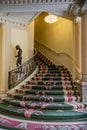 Interior staircase with flowered carpet and ornament sculpture