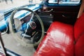 Interior and steering wheel with red leather seats on old vintage retro car Royalty Free Stock Photo