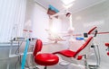 Interior of a stomatologic cabinet. Red chair and white walls. Royalty Free Stock Photo