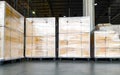 Interior of storage warehouse, stack of package boxes on pallets