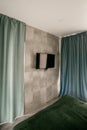 Interior of stylish green bedroom with concrete wall. Royalty Free Stock Photo