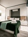 Interior of stylish green bedroom with white wood wall. Royalty Free Stock Photo