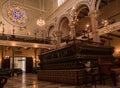 Interior of a synagogue with bimah in middle. Synagogue is Jewish house of worship for the purpose of Jewish prayer, study,