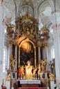 Interior of tall cathedral with elaborate altar