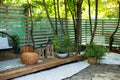 Interior Terrace with plants and wooden porch of house. Houseplants in pots in courtyard. Cozy garden corner. Patio of house with