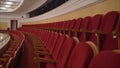 The interior of the theater arts. The auditorium with seats and balcony. Soft focus. Seats in the theater. Red seat on the balcony