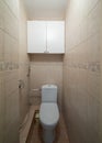 Interior of toilet in flat. Modern apartment. Beige tile with pattern.