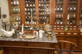 The interior of the trading hall of an old pharmacy with showcases and a table for preparing preparations