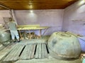 Interior of traditional Georgian bakery with circular clay oven, Kutaisi, Georgia, 5.08.2022.