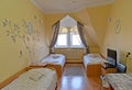 Interior of the triple hotel room with a portrait of the Russian poet Sergey Yesenin on a wall