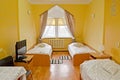 Interior of the triple hotel room in yellow tones