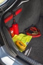 Interior of the trunk of the car in which there is a first aid kit, fire extinguisher, warning triangle, reflective vest, star Royalty Free Stock Photo