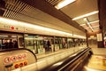 Interior of the underground station of asian city and passengers inside trains