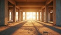 Interior of unfinished building with concrete pillars, floor. Sunlight streams through windows at end of room. Construction site Royalty Free Stock Photo