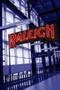 The interior of Union Station train depot in Raleigh, NC, with a neon Raleigh sign