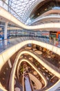 interior view of atrium and escalator hall with curvature corridor of Myzeil, modern shopping mall in Frankfurt