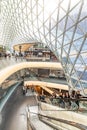 interior view of atrium and escalator hall with fascinate curvature corridor of Myzeil, designed shopping mall