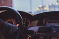 Interior view of a car with focus on the gauges and clock and bokhed bolls in the windshield Royalty Free Stock Photo