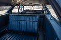 Interior view of classic long station wagon with wood-veneered doors, it's a blue Ford Gran Torino.