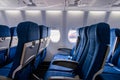 Interior view of economy coach seats inside of passenger airplane