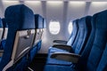 Interior view of economy coach seats inside of passenger airplane